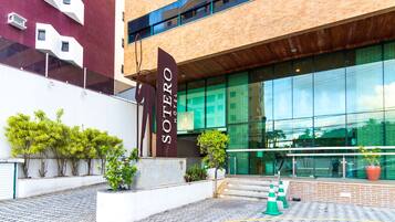 Stylish hotel entrance with a touch of greenery.