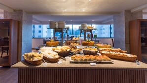 A buffet with various breads, pastries, and desserts. - Sotero Hotel (Salvador)