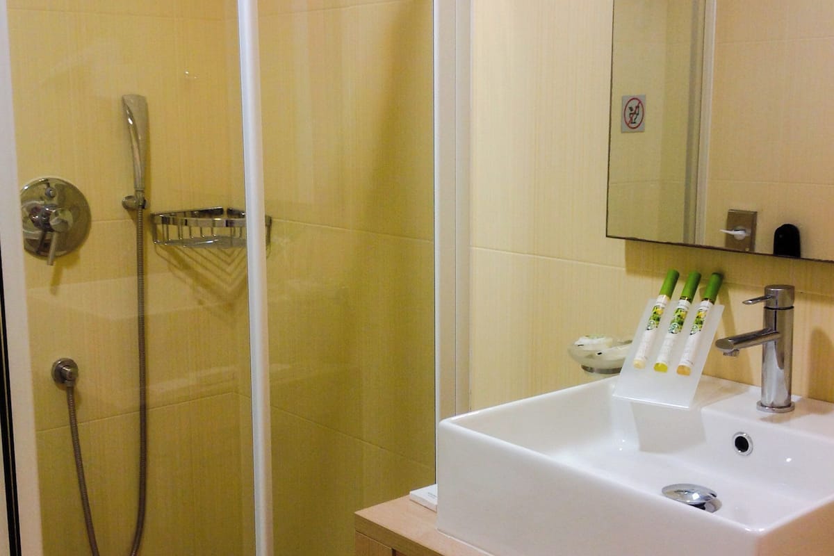 double room, garden view | bathroom | designer toiletries, hair dryer, bathrobes, slippers