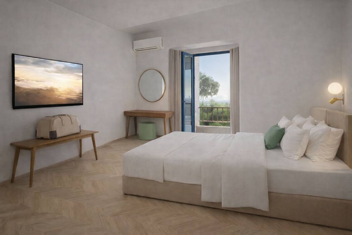 A modern bedroom with a bed, bedside table, bench, and a large window.