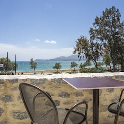On the beach, sun loungers, beach umbrellas, windsurfing