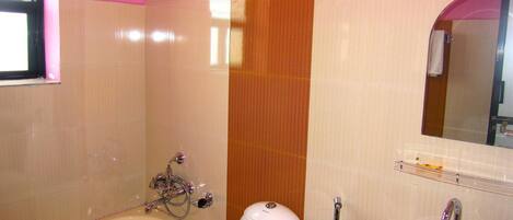 A bathroom with a bathtub, toilet, and sink.