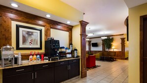 A modern kitchen with a coffee machine, condiment bottles, and a framed artwork above the counter. - Best Western Plus Landmark Hotel (Roosevelt)