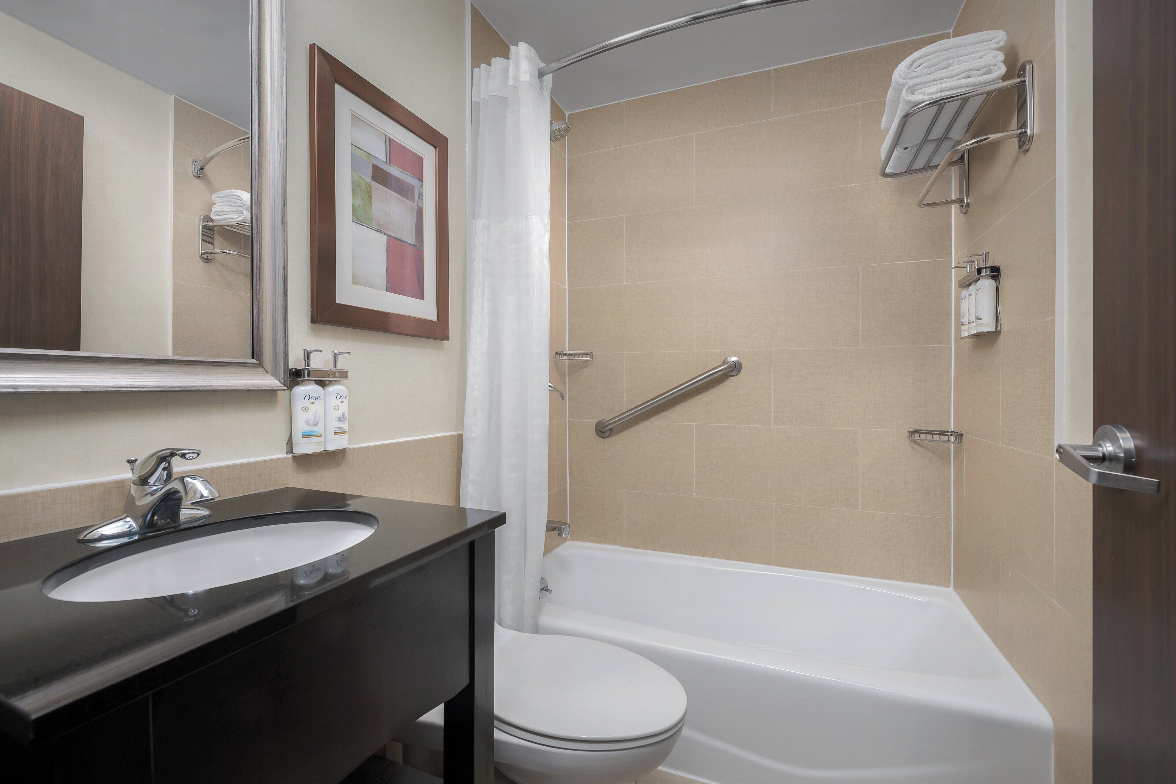 A bathroom with a sink, toilet, and bathtub.