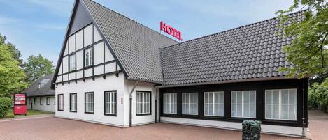 A traditional building with a steeply pitched roof and a prominent 'HOTEL' sign.