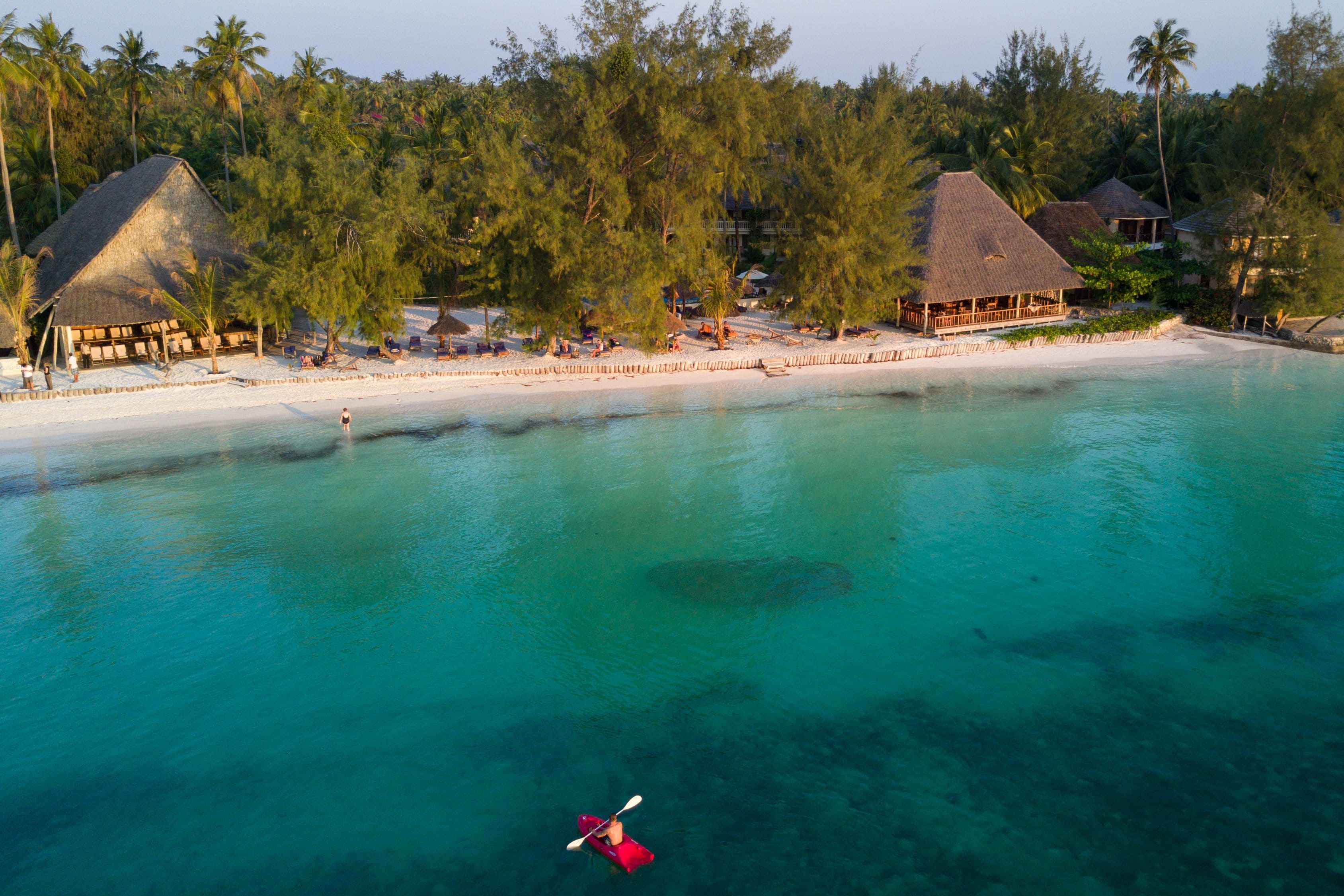 On the beach, white sand, sun loungers, beach umbrellas