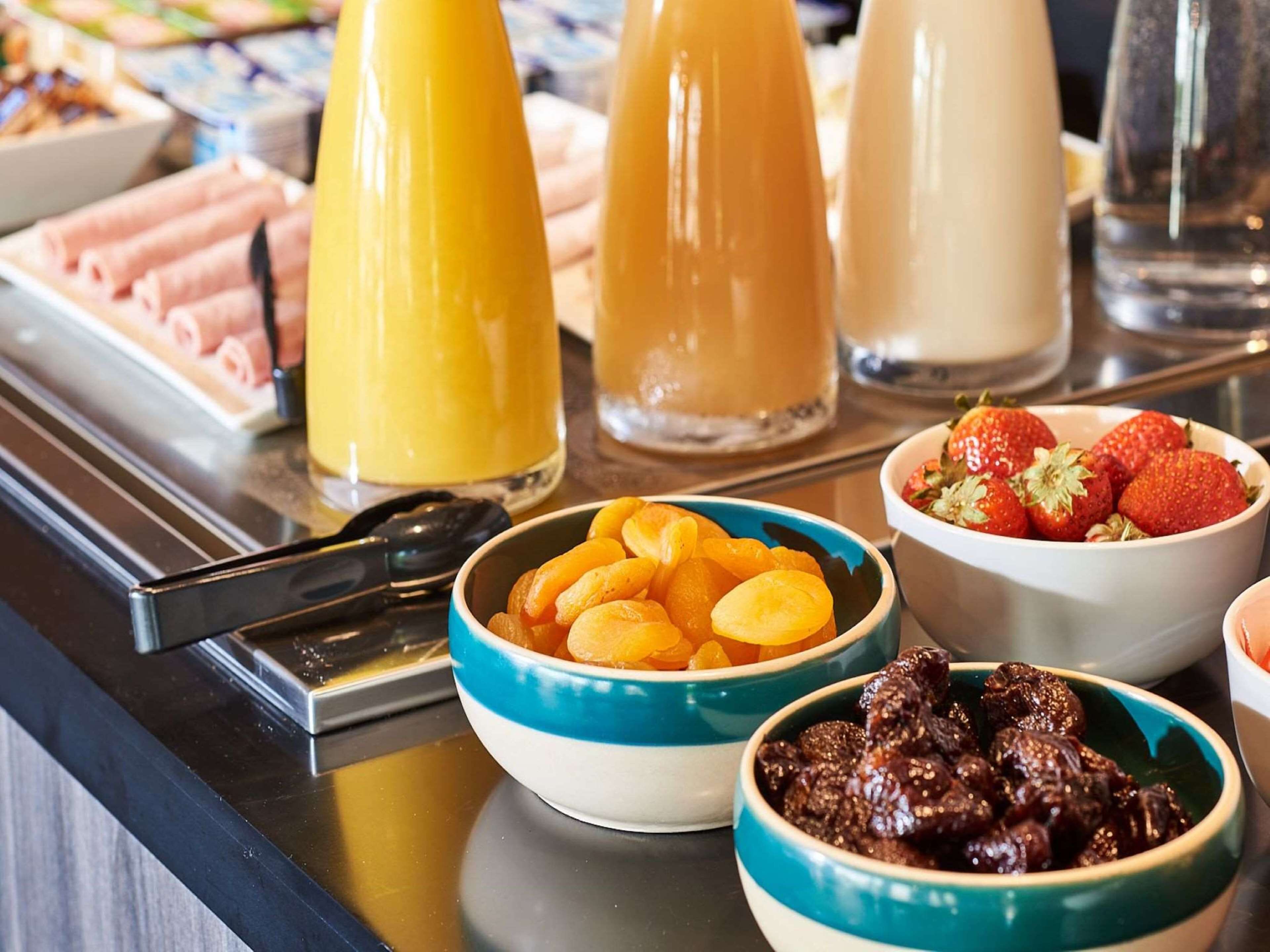 A buffet table with various food items and beverages.