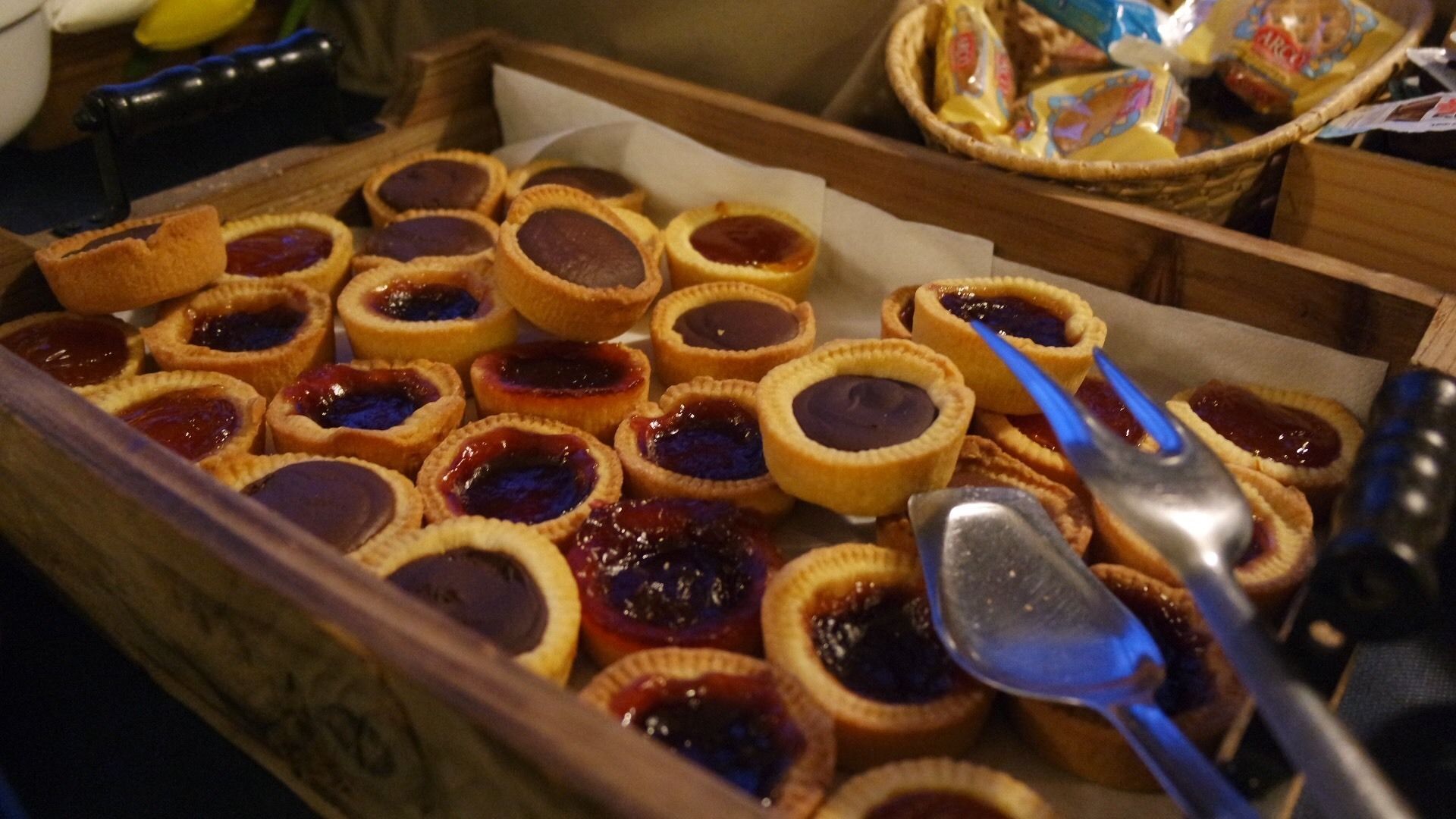 Un vassoio con diversi pasticcini accompagnato da un cucchiaio e una forchetta.