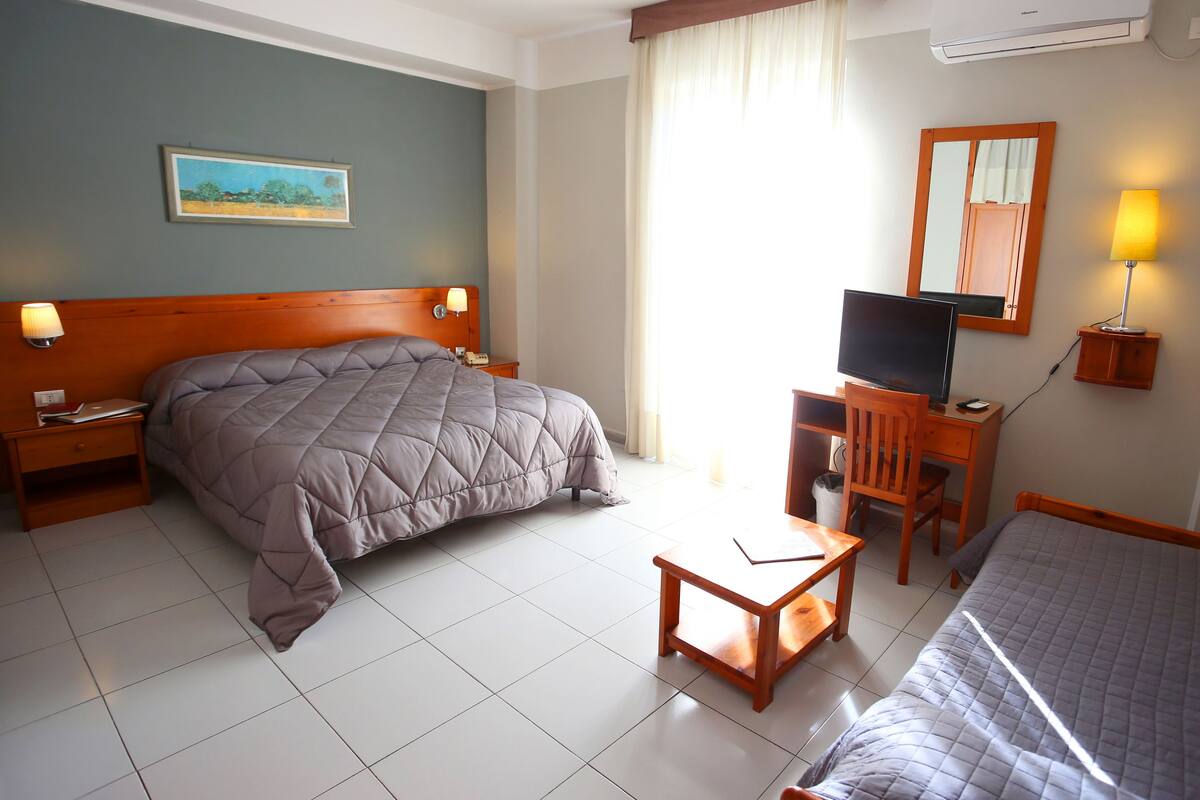 Standard Triple Room | Living area | Flat-screen TV