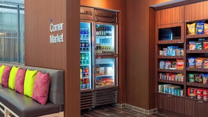 A corner market with refrigerated display cases and shelves stocked with snacks and beverages. - Fairfield Inn & Suites Chicago Downtown/River North (Chicago)