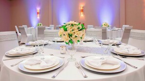 A banquet hall with round tables set for a formal event, featuring white tablecloths, silverware, and floral centerpieces. - Courtyard Killeen Marriott (Killeen)