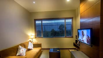 Deluxe Apartment, 2 Bedrooms | Living area | 32-inch LED TV with cable channels, TV, DVD player