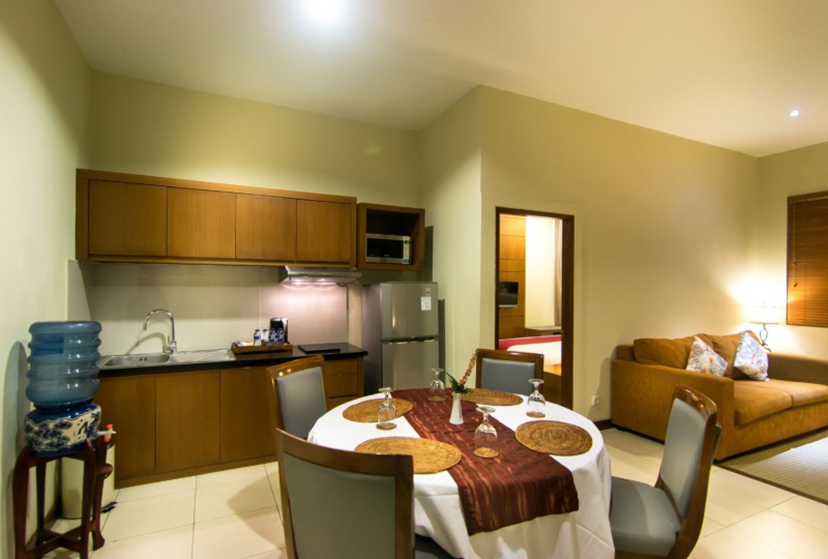 A compact living space with a kitchen, dining area, and a sofa.