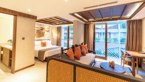 A hotel room with a bed, a sofa, a dining area, and a balcony with a view. - Episode Kuta Bali (Kuta)