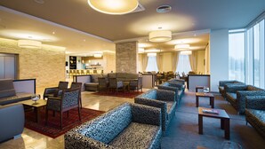 A spacious lobby with multiple seating areas, a bar, and large windows providing natural light. - Medjugorje Hotel & Spa (Citluk)