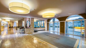 A spacious lobby with a marble floor, large windows, and a reception desk. - Medjugorje Hotel & Spa (Citluk)