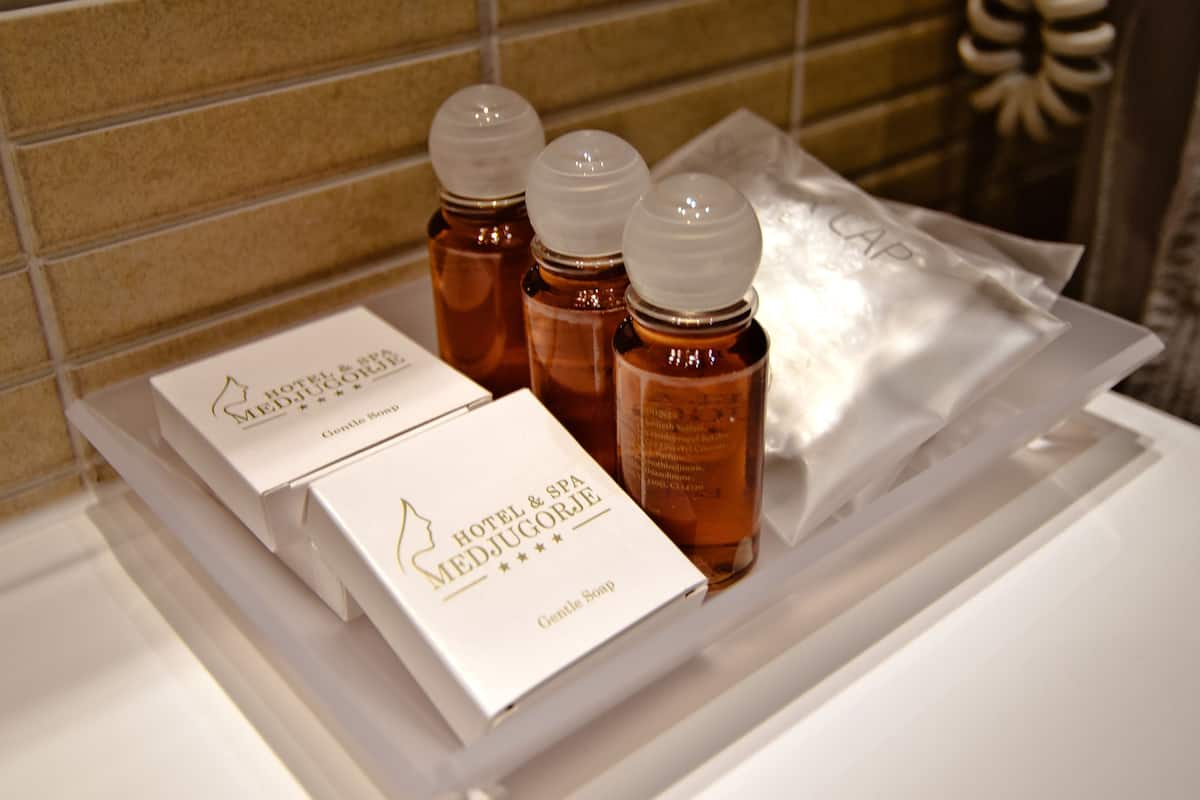 shower, designer toiletries, hair dryer, slippers