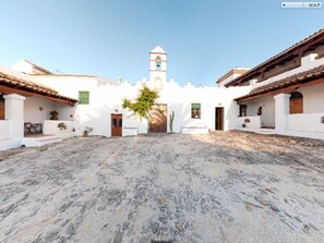 Stroll through this charming courtyard, surrounded by historic buildings and a picturesque bell tower.