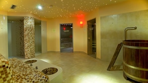 Un área de spa con suelo a cuadros, un barril de madera y una pared de azulejos con un diseño de mosaico.