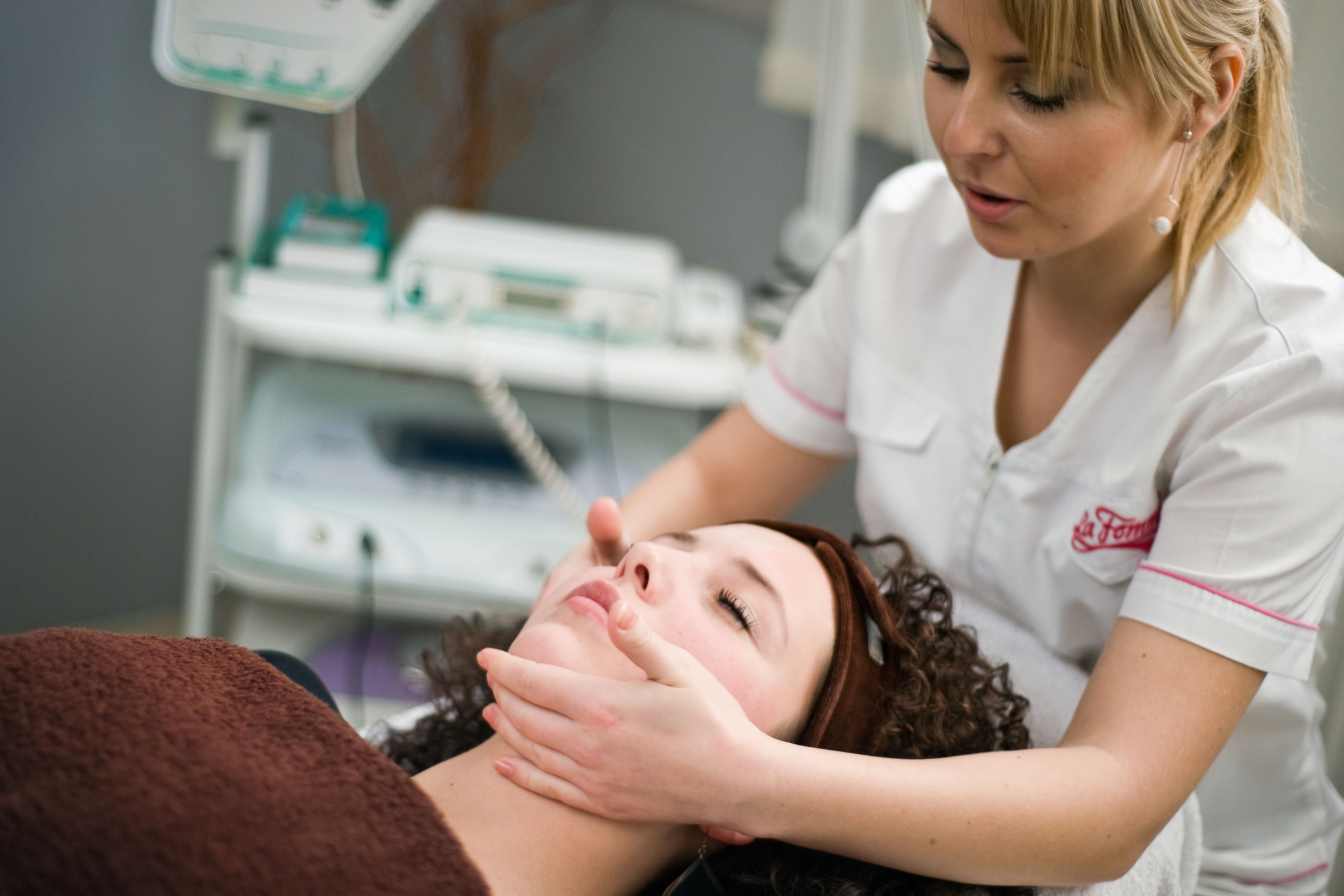 A person lying down with a medical professional attending to them.