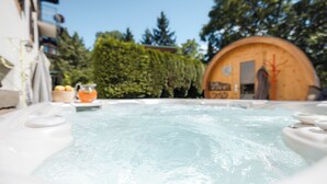 A hot tub with a wooden structure in the background. - Bio Boutique Hotel Laurino (Cavalese)