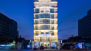 A multi-story hotel with a modern facade, large windows, and a prominent entrance. - Romeliess Hotel (Ho Chi Minh City)