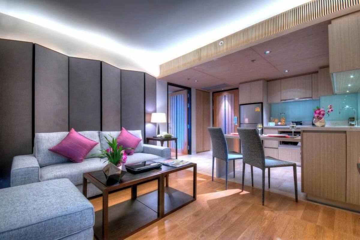 Una sala de estar moderna con un sofá, una mesa de centro y un comedor con sillas.