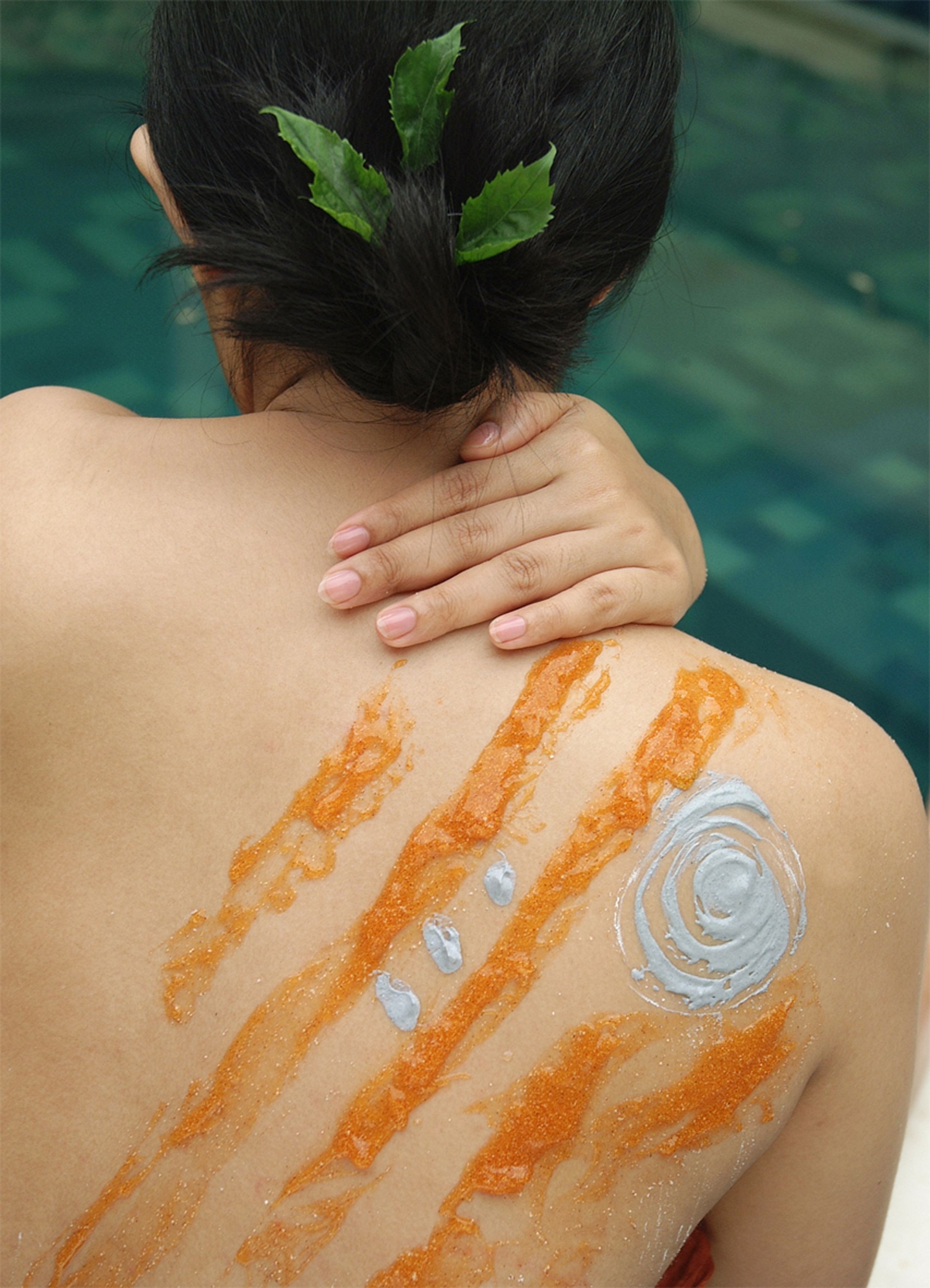 A person with a back massage and decorative patterns on their back.