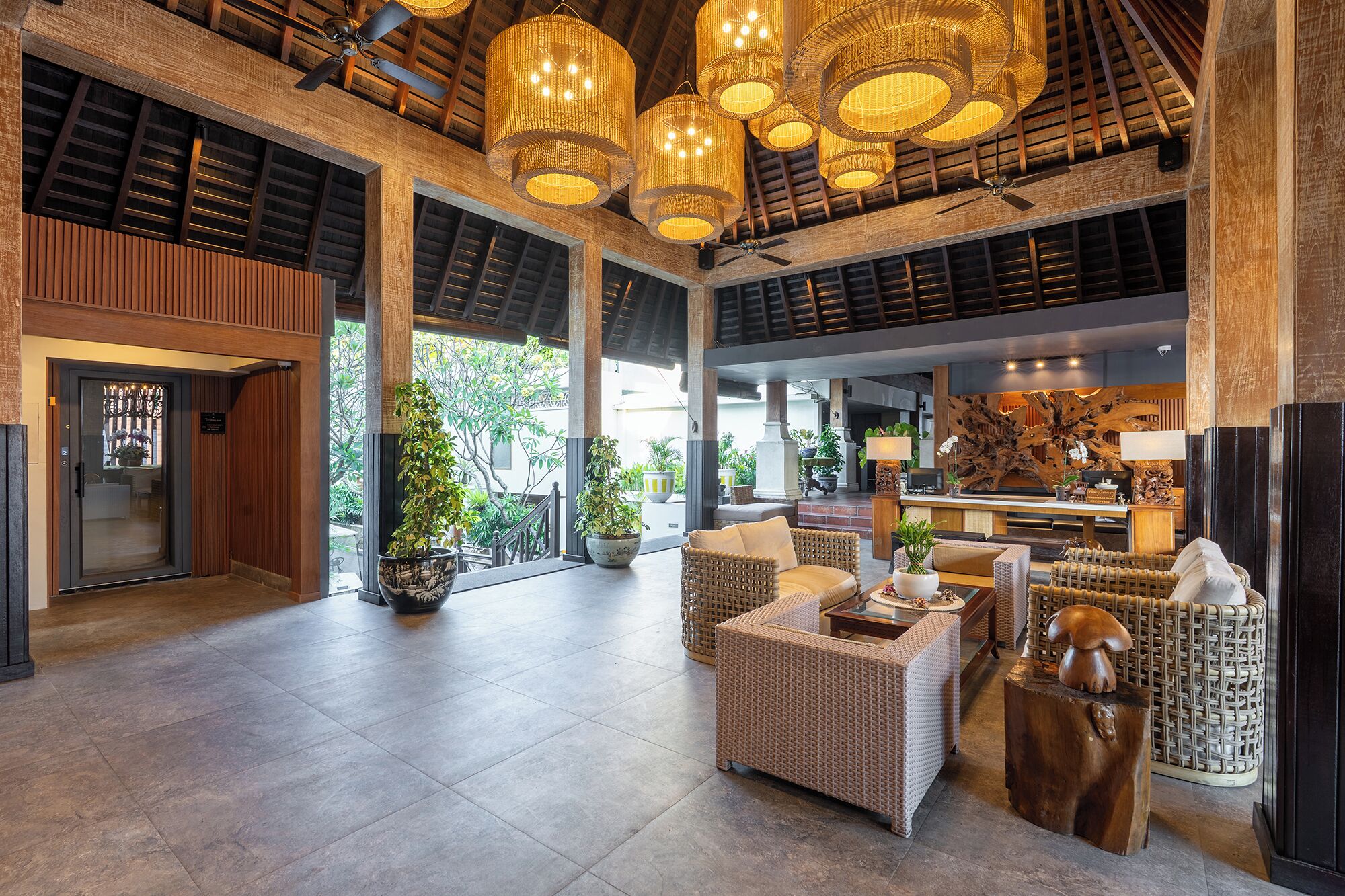 A spacious lobby with high ceilings, large windows, and a reception desk.