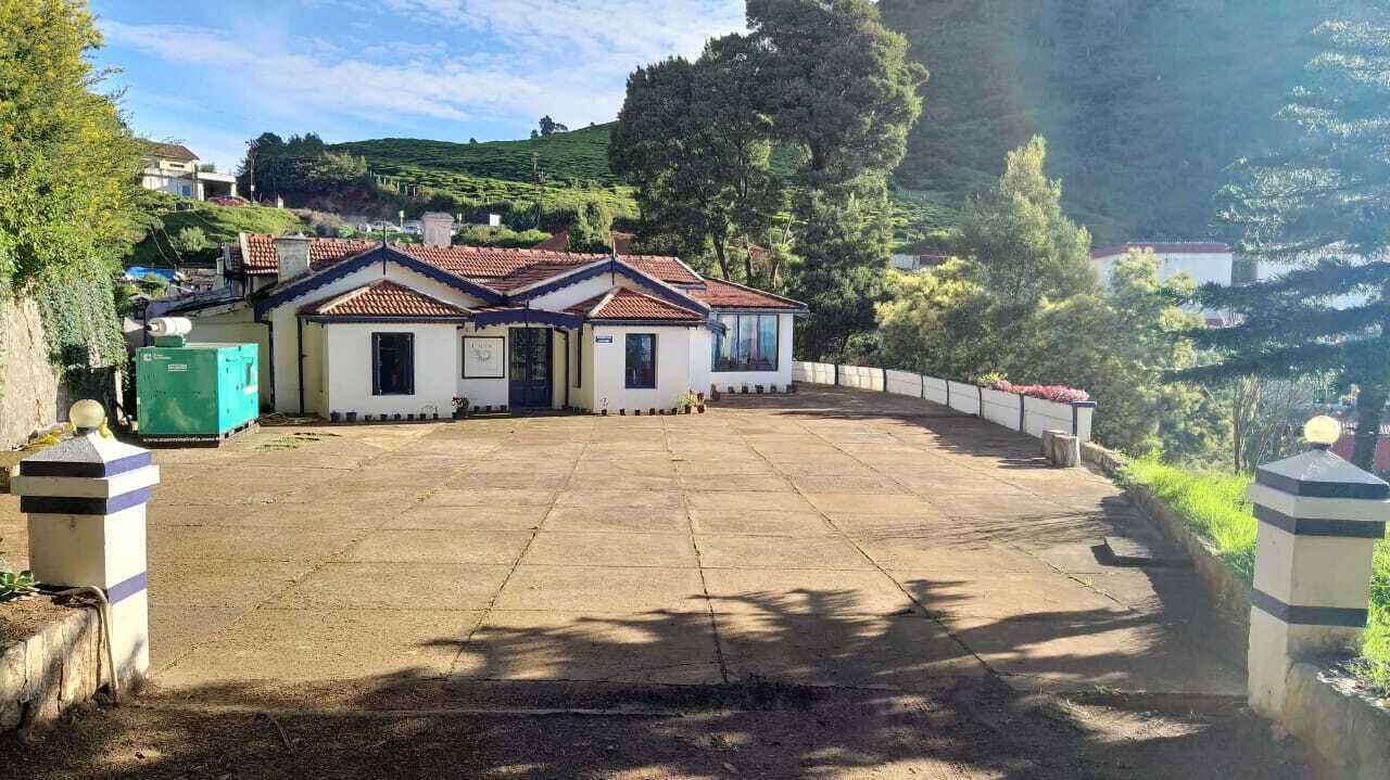 A building with a tiled roof and a paved courtyard.