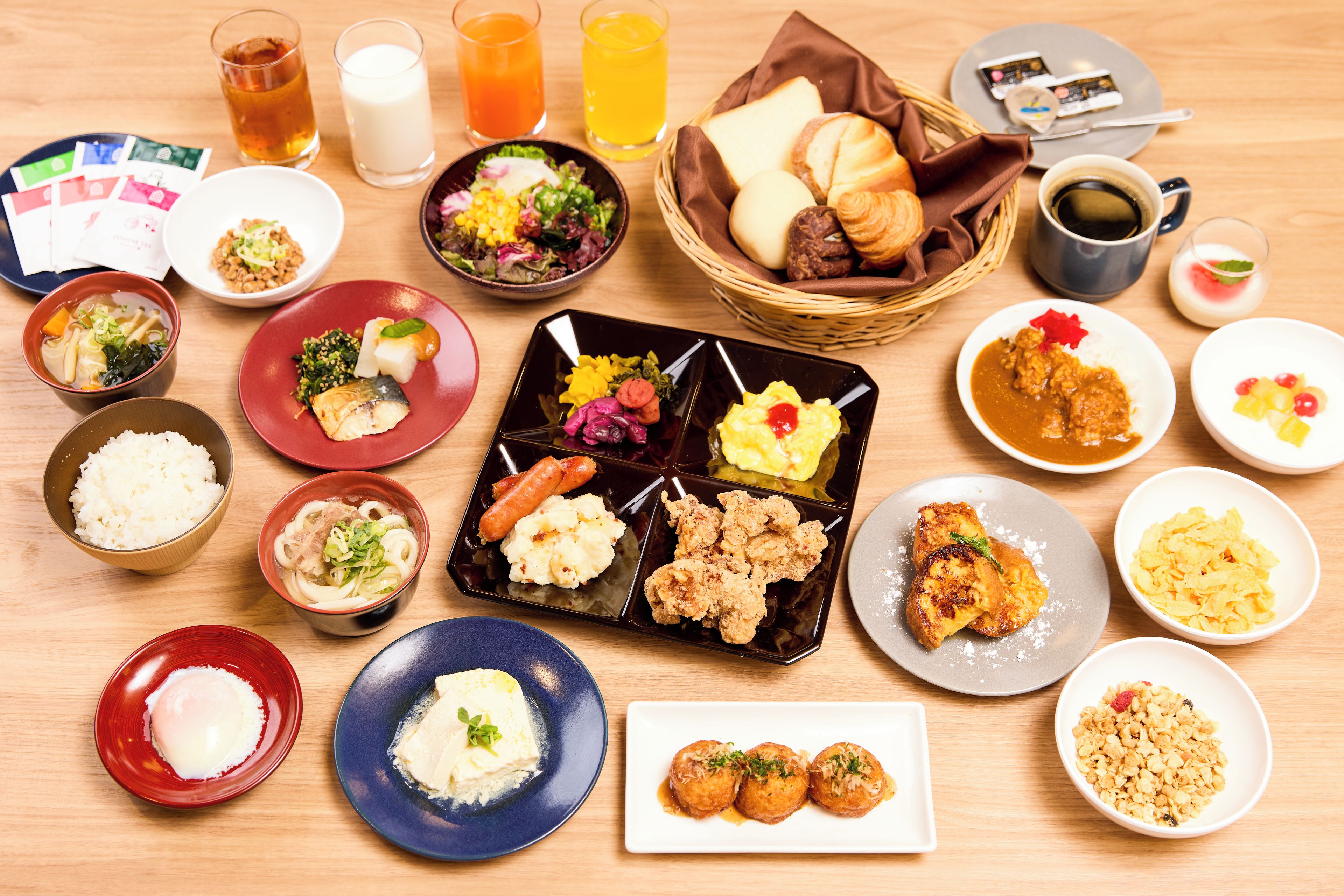 A variety of Japanese dishes arranged on a wooden table.