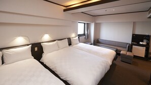 A hotel room with two beds, a desk, a chair, and a small kitchenette. - Hotel Consort Shin-Osaka (Osaka)