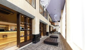 A spacious lobby with a marble floor, seating areas, and a reception desk. - Hotel Consort Shin-Osaka (Osaka)