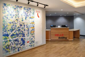 A reception desk with a map and a 'HELLO Redding' sign.