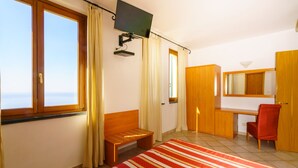 A bedroom with a bed, a desk, a chair, a TV, and a wardrobe. - Luna di Marzo (Volastra)