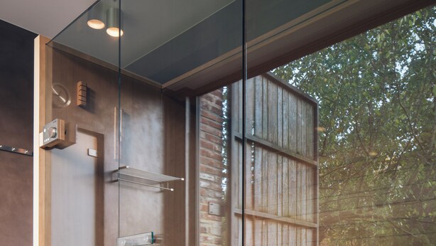 A modern bathroom with a glass partition, wooden elements, and a view of the outdoors. - Park 7 (Huldenberg)