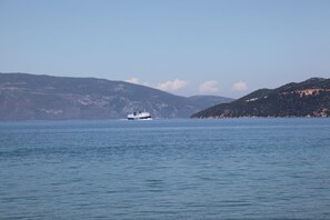 A large body of water with a boat in the distance. - Kalypso Studios & Apartments (Kefalonia)