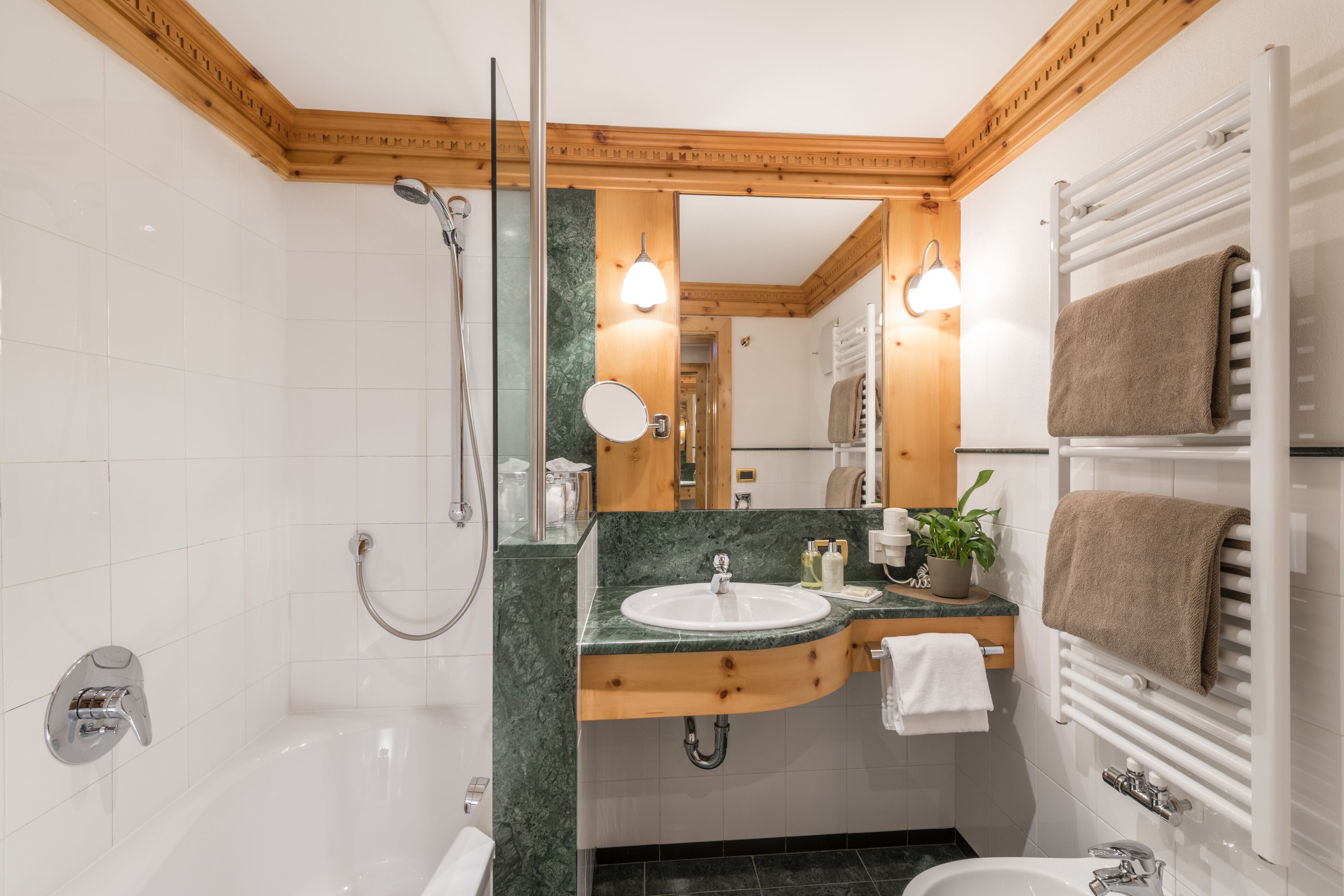 A modern bathroom with a bathtub, a sink, and a mirror.
