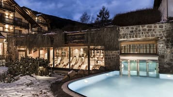Relax by the pool surrounded by a tranquil mountain landscape.