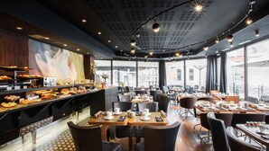 A restaurant with a buffet, dining tables, chairs, and large windows. - Best Western Premier Why Hotel (Lille)