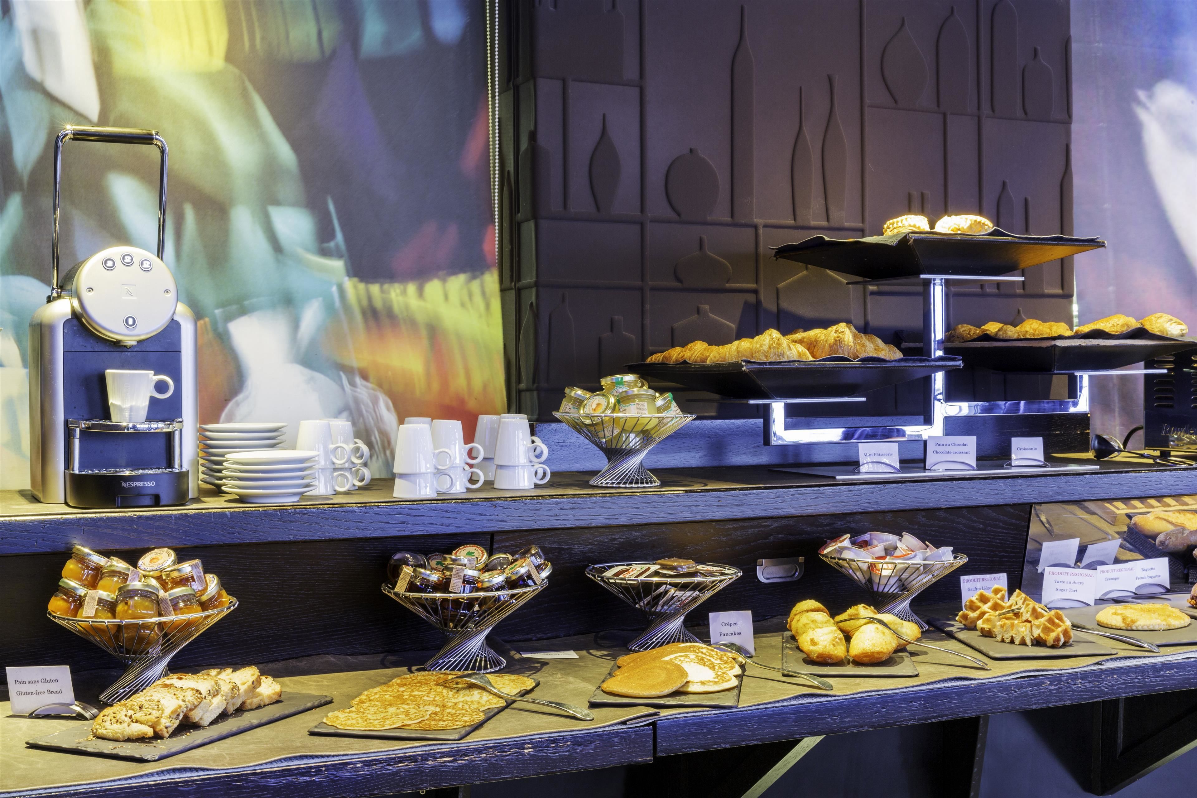 A buffet with various food items and a coffee station.