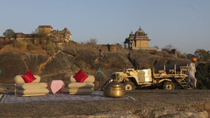 A rugged outdoor setting with a vehicle and a person.