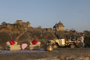 A rugged outdoor setting with a vehicle and a person.