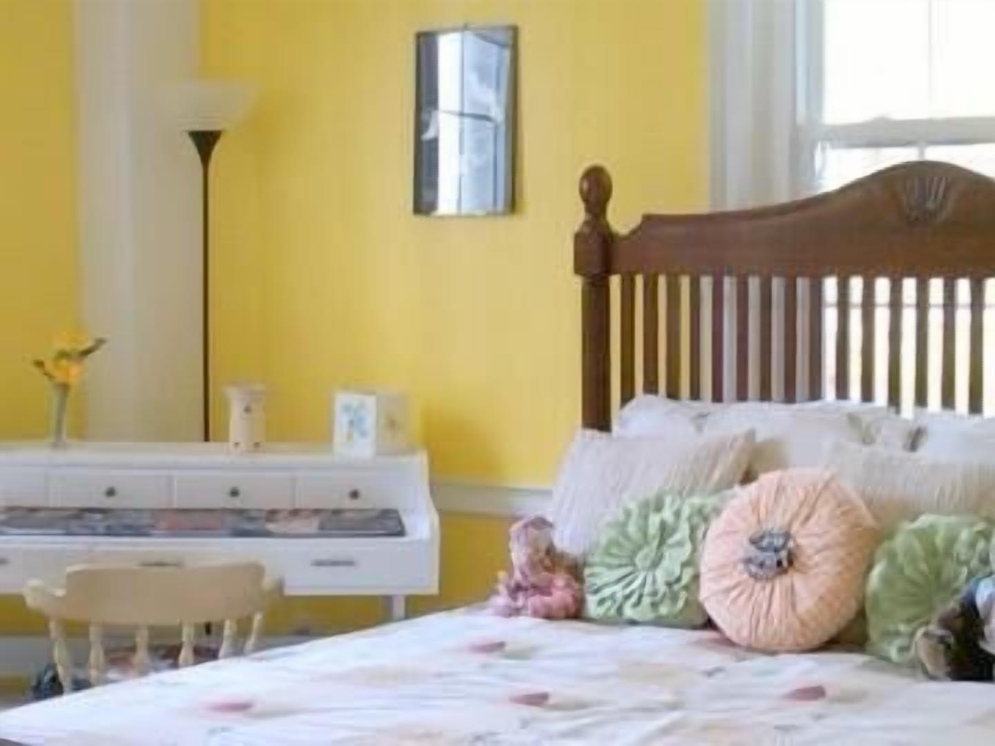 A bedroom with a bed, a dresser, and a nightstand.