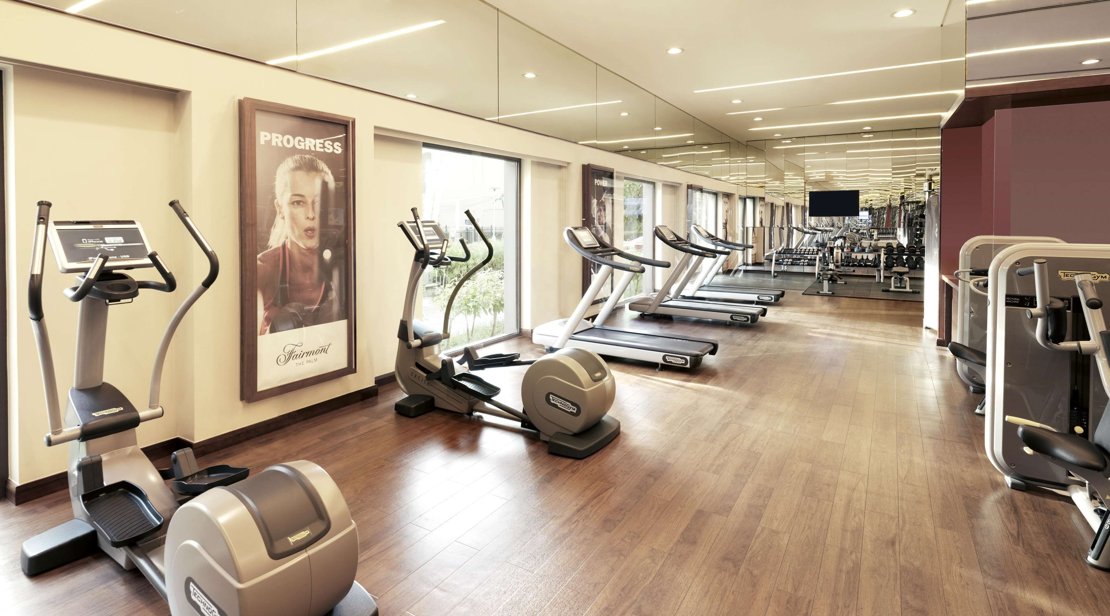 A gym with treadmills, elliptical machines, and weight machines.