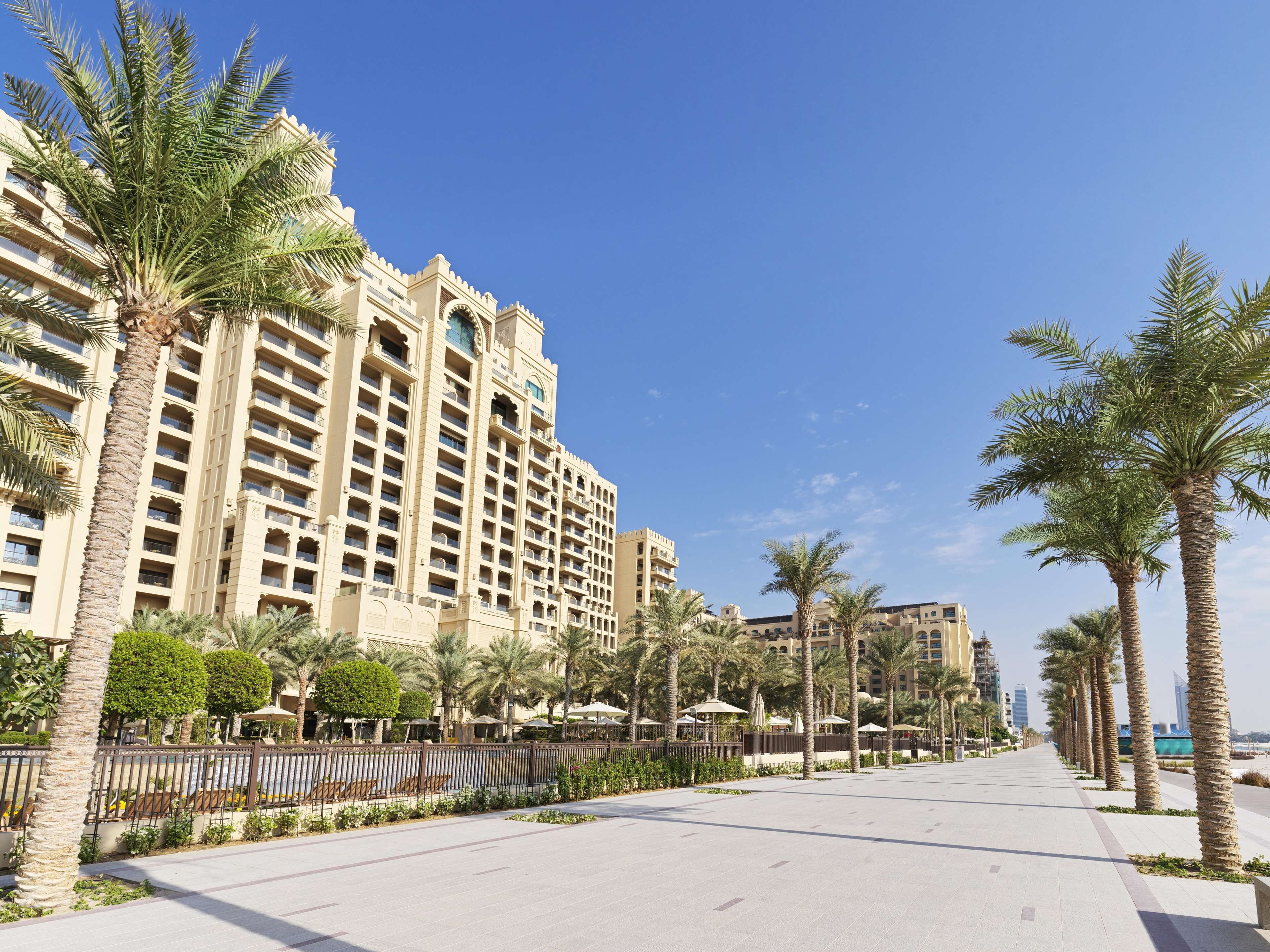 A hotel with a modern architectural design, featuring multiple floors and balconies.