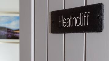 A door with a sign reading "Heathcliff" mounted on it.