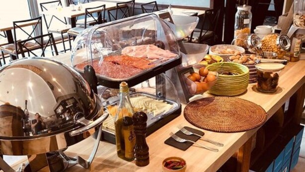 A buffet setup with various food items and condiments. - B-aparthotel Regent (Brussels)