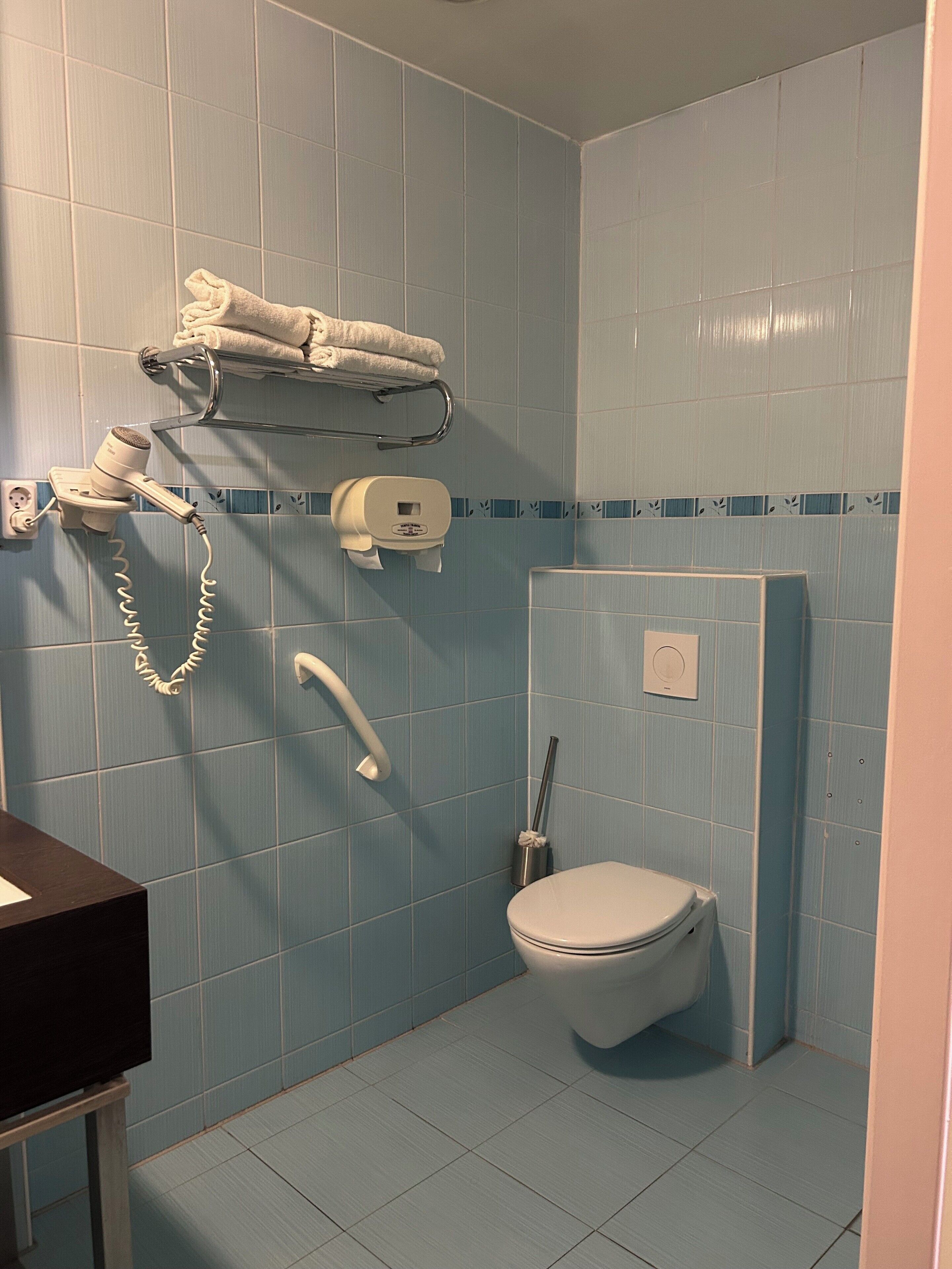 basic twin room, no windows | bathroom | shower, free toiletries, hair dryer, towels