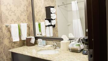 A bathroom with a sink, mirror, towel rack, and a shower curtain.